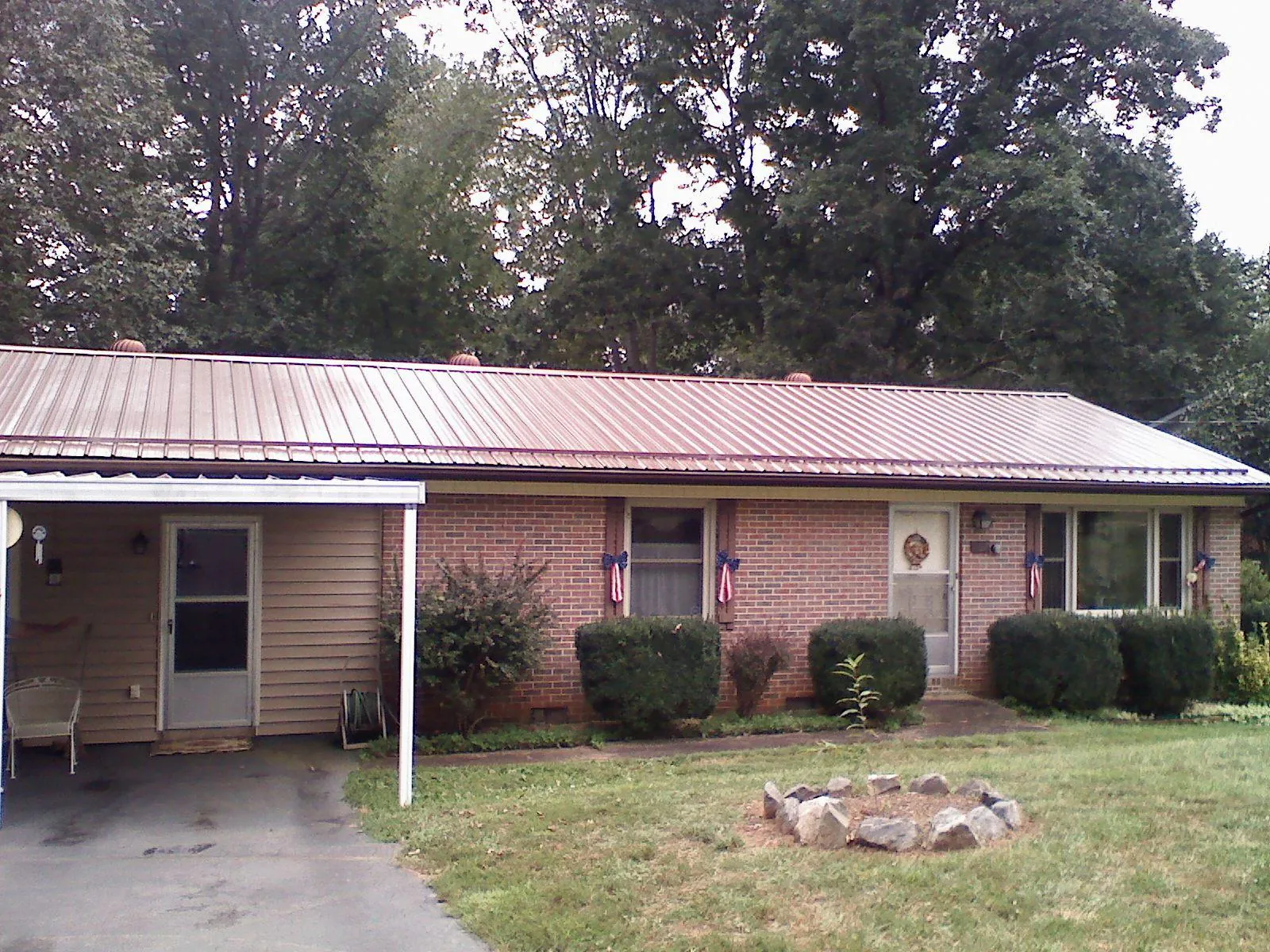 Bronze metal roof and carport on a brick ranch home — Roof Repair work by our crew in Port Chester