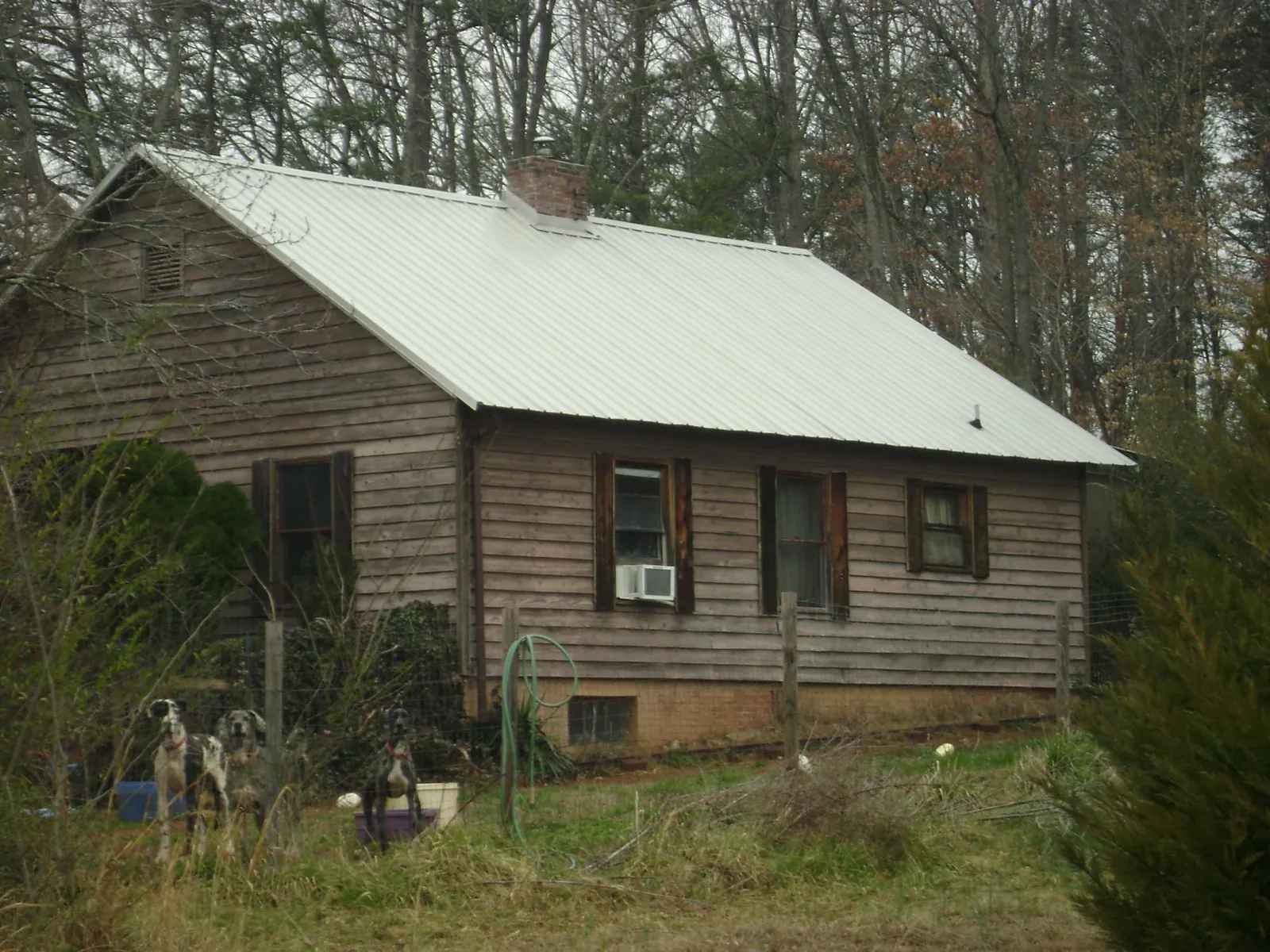 White metal roof on an old wood sided farmhouse, from a Metal Roof Installation job in Port Chester